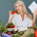 Vlogger promoting healthy eating with fresh vegetables on the table.