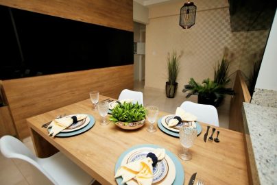 Contemporary dining area featuring a stylish wooden table set with elegant crockery and glassware.